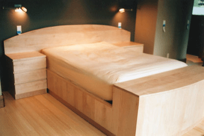 floating maple platform bed with integrated night stands and foot chest