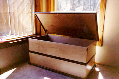 walnut and maple blanket box doubles as a sitting banco